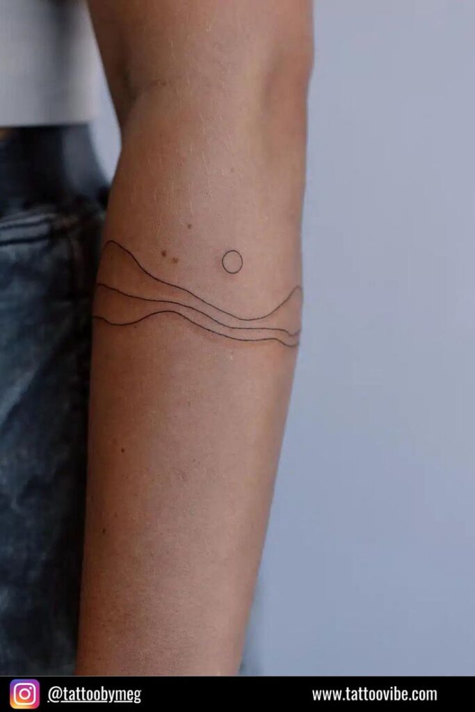 Elegant wave tattoo on a womans arm